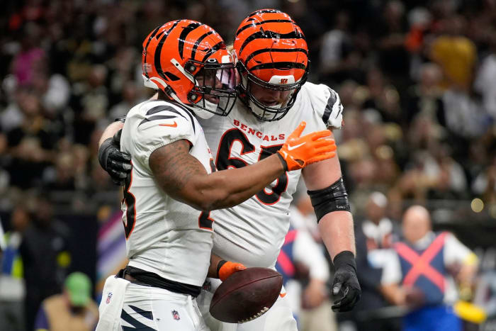 Cincinnati Bengals guard Alex Cappa (65) congratulates Cincinnati Bengals running back Joe Mixon (28) after a touchdown in the first quarter during an NFL Week 6 game against the New Orleans Saints, Wednesday, Oct. 6, 2021, at Mercedes-Benz Superdome in New Orleans. Cincinnati Bengals At New Orleans Saints Oct 16 010